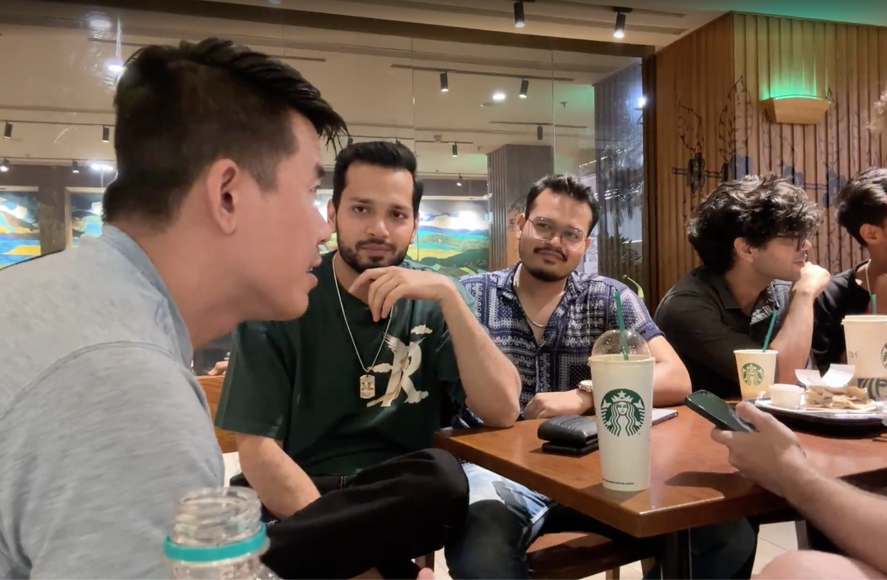 Mike Ke with a group of Indian students inside a shopping mall
